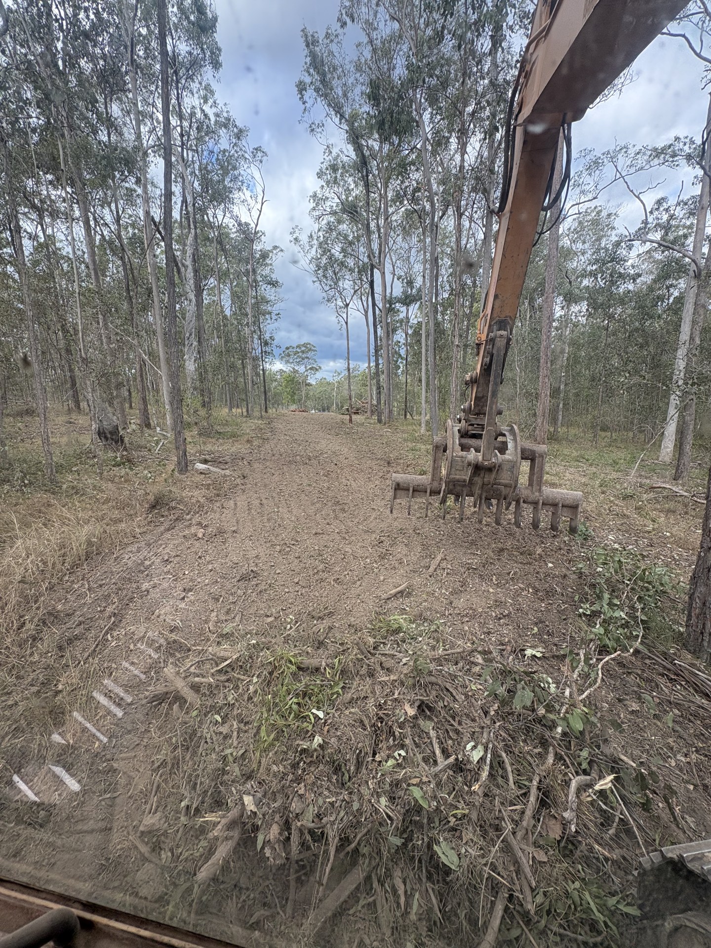 Excavator pushing out dense regrowth during land clearing at Glenwood QLD