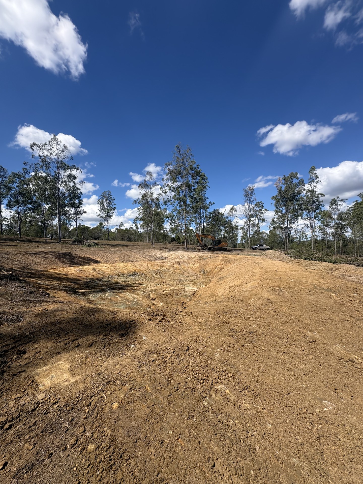 Desilted farm dam with freshly shaped batters and rebuilt wall near Gympie QLD