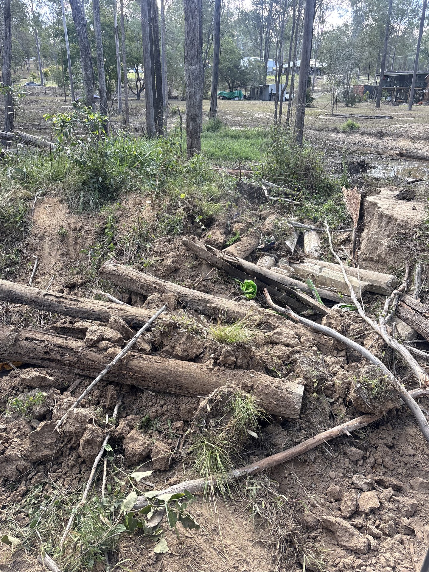 Collapsed dam wall with fallen timber and slumped soil before repair at Curra QLD