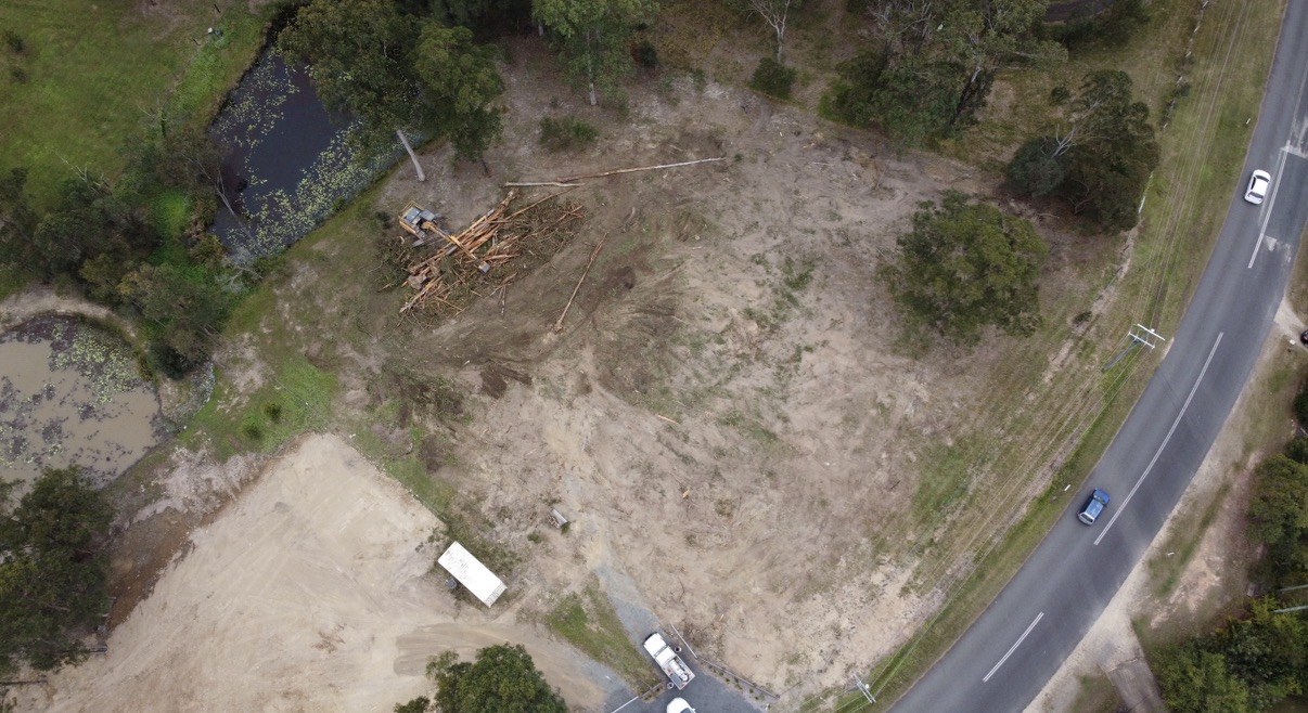 Aerial view of cleared open ground beside a road after clearing near Gympie QLD