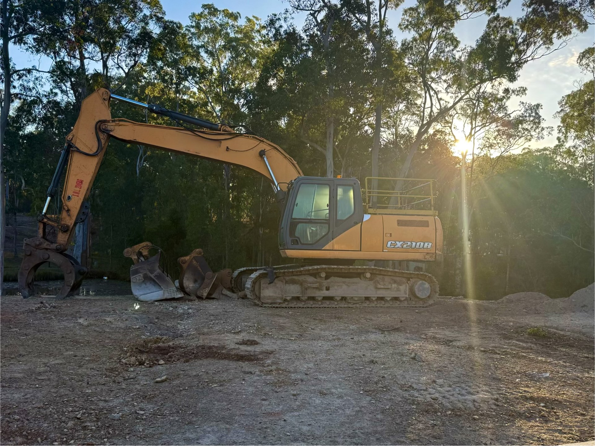 21 tonne Case CX210B excavator with buckets and grab on site at sunset near Gympie QLD